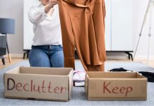 Image: A woman sorts clothing into boxes labeled "declutter" and "keep" as a way to give back