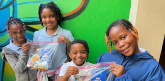 Image: Children holding snack packs assembled and distributed by Branches, a local nonprofit in Miami-Dade