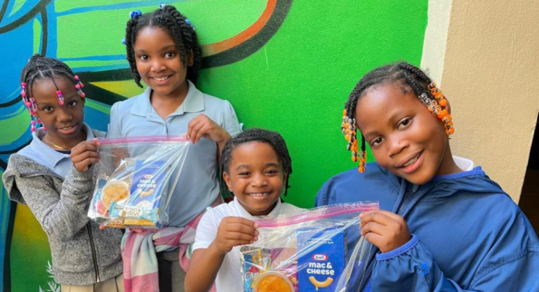 Image: Children holding snack packs assembled and distributed by Branches, a local nonprofit in Miami-Dade