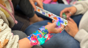Image: Children playing with light-up bracelets and slap bracelets