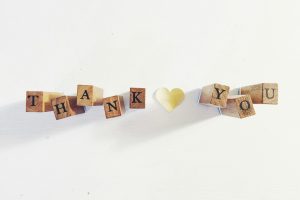 Image: Wooden blocks spell out "Thank You" against a white background