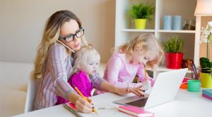 Image: A mom working from home with two toddlers