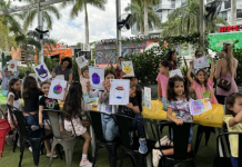 Image: Children at Miami Mom Collective's Comic Kids event hold up pictures of their squish mallows