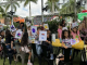 Image: Children at Miami Mom Collective's Comic Kids event hold up pictures of their squish mallows