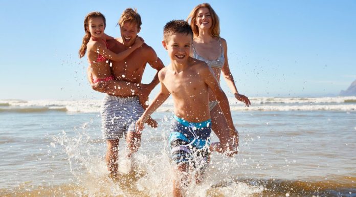 Image: A family playing in the surf at the beach