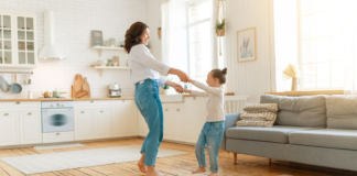 Image: A mom and daughter dance in the living room