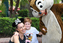 Image: A mother and son pose for a photo with Chip and Dale