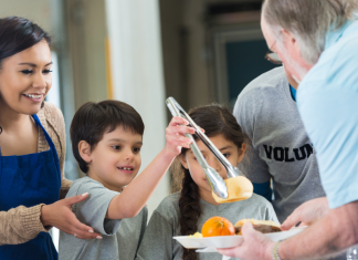 Image: A family serves a meal together