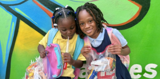 Image: Two children hold their holiday snack packs