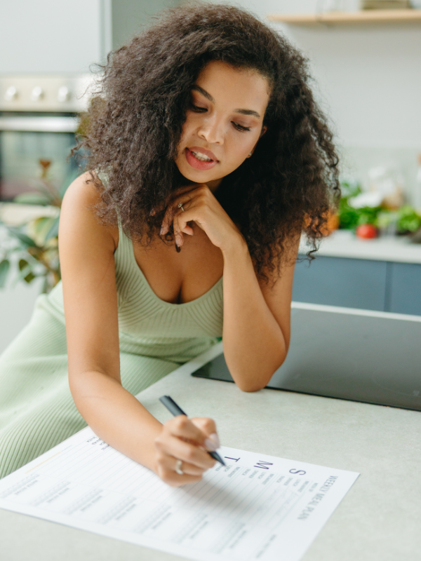 Image: A woman writing a weekly plan